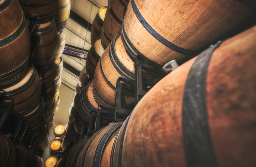 Wine aging in stacks of wine barrels