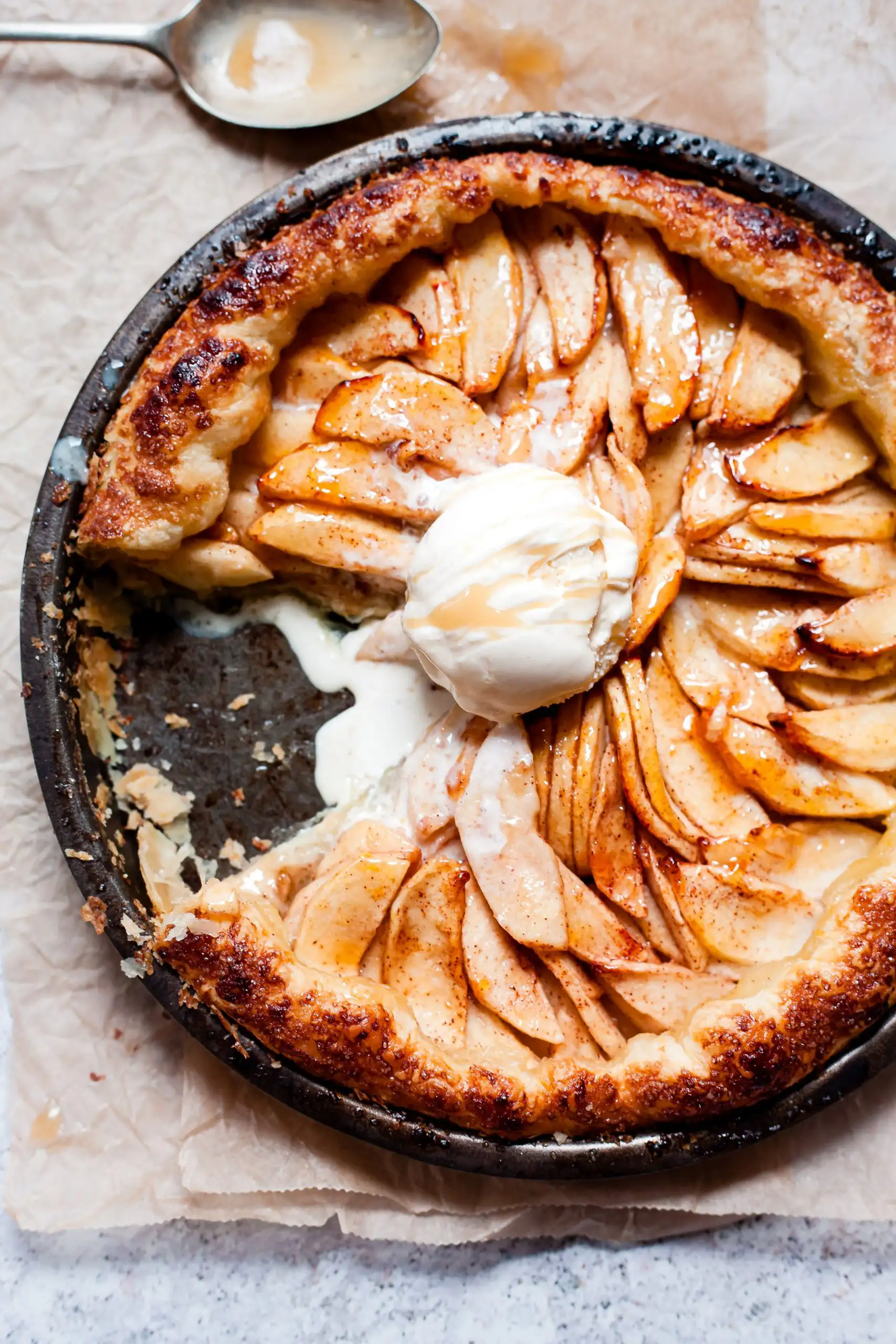 Don't Miss These Wine and Dessert Pairings | Domenico Winery A rustic apple tart with a flaky golden crust topped with a melting scoop of vanilla ice cream and caramel drizzle.